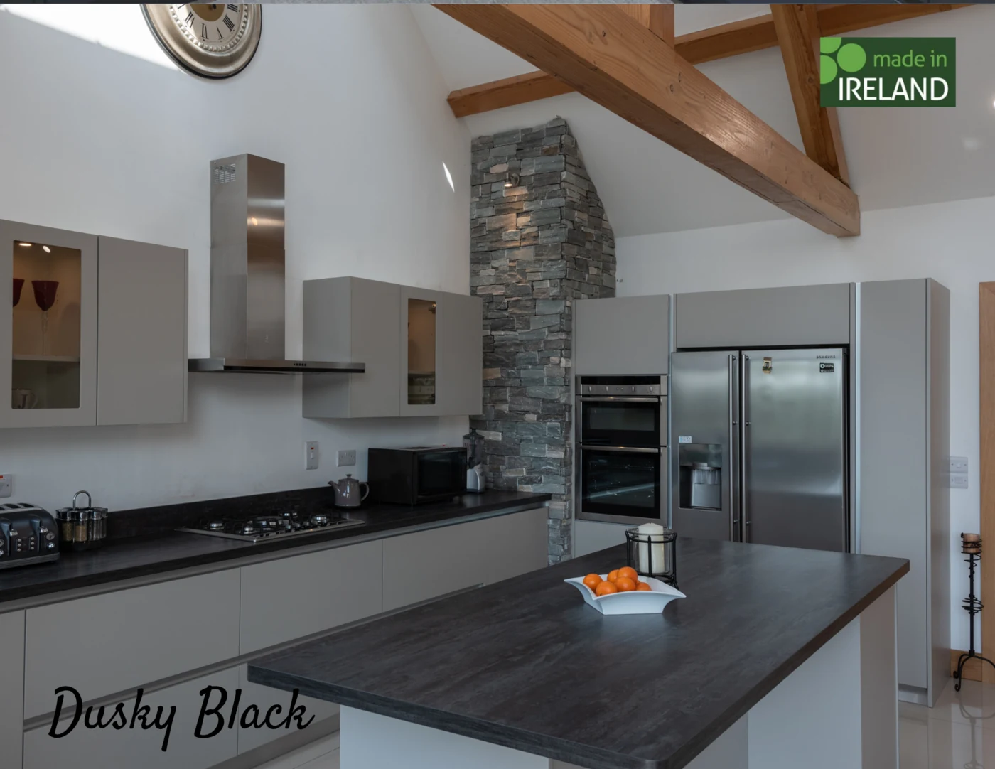 Quartz and Terrazzo collection laminate worktop with dark speckled composite finish resembling engineered stone