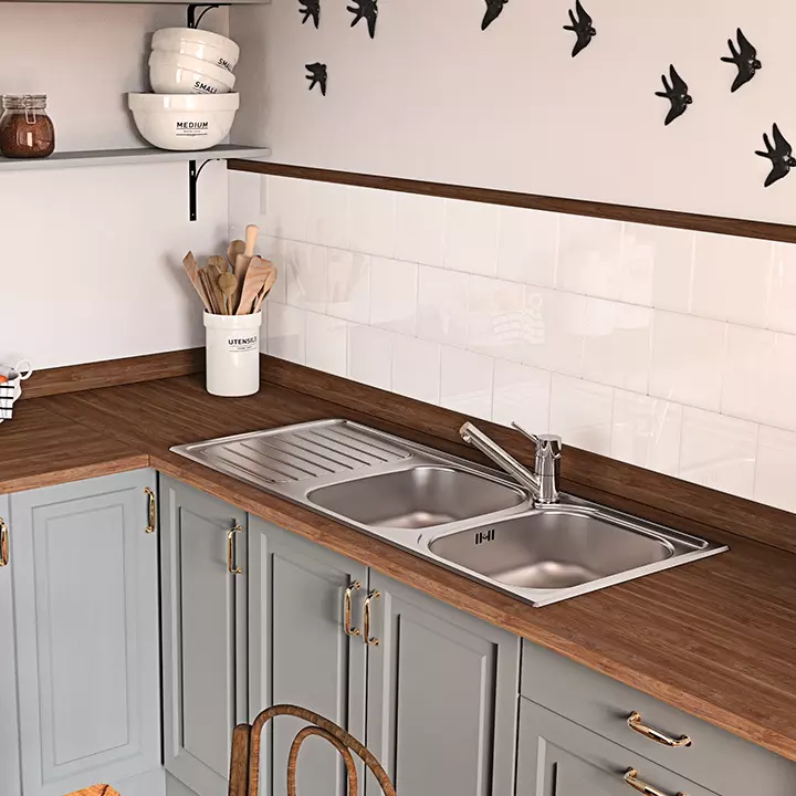 Double bowl kitchen sink with drainer, suitable for high-usage installations requiring separate washing and rinsing zones